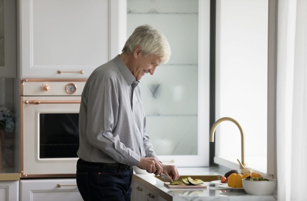 A senior cuts & prepares keto-friendly avocados at home.